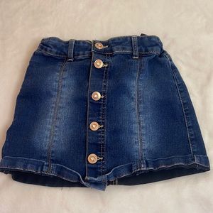 Denim skirt, rose gold buttons.